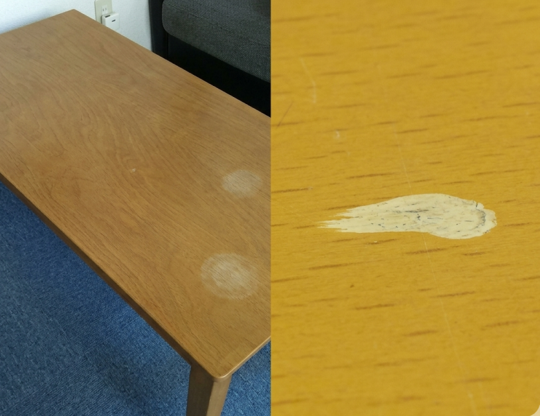 作業スタッフが修復対象である木のテーブルのキズ(約1cm)の大きさと状態を確認している様子
